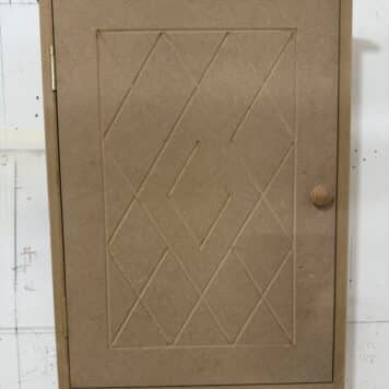 a cabinet built with a diamond pattern door by a student