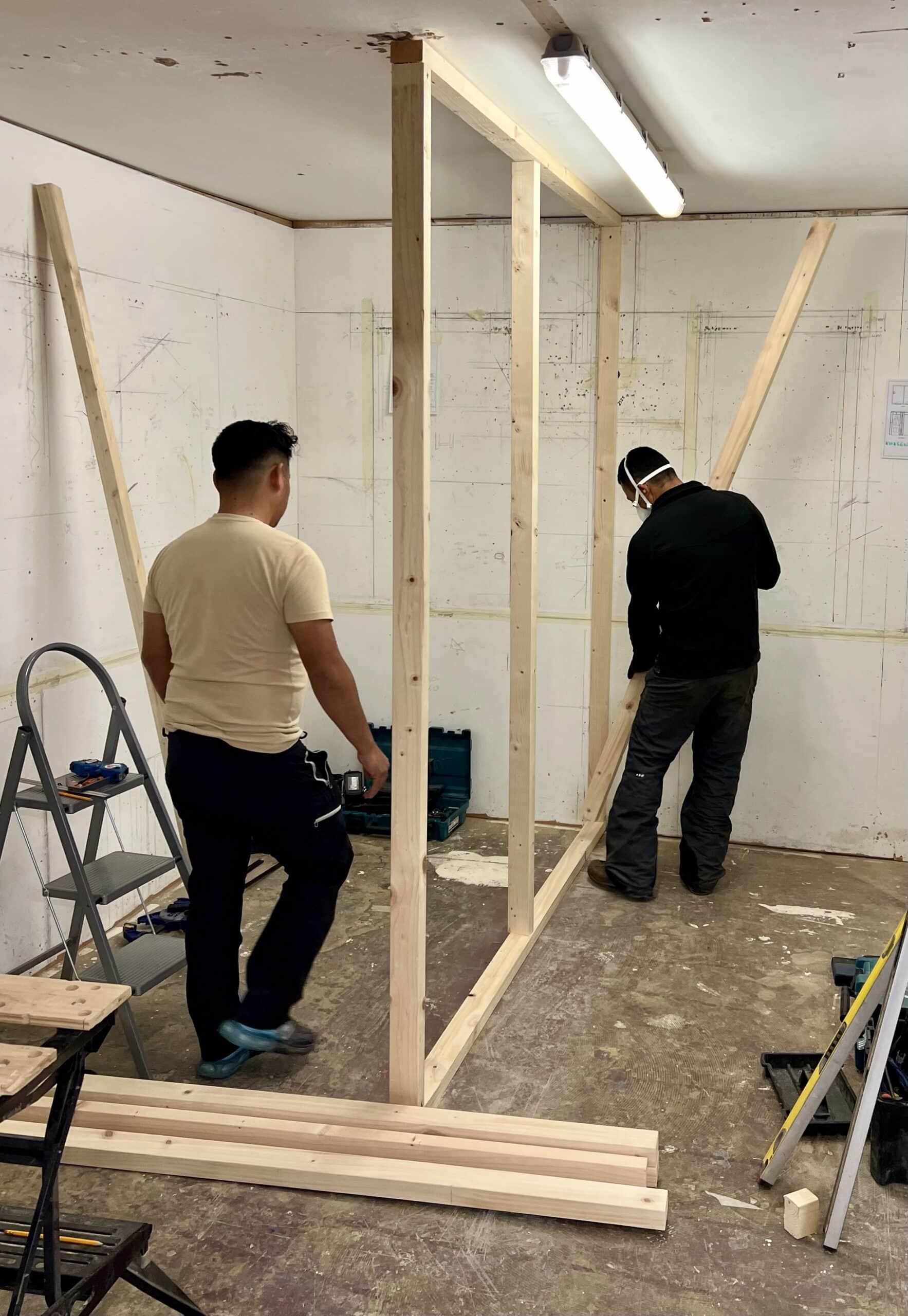 People on course building a stud wall