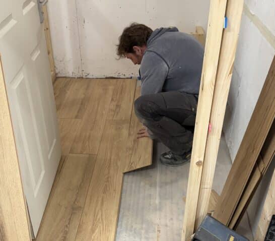 Person fitting laminate flooring
