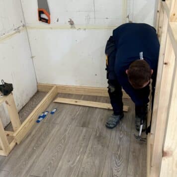 Person fitting skirting boards