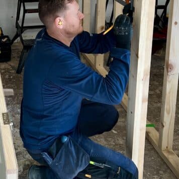Person measuring ready to cut out for a door hinge
