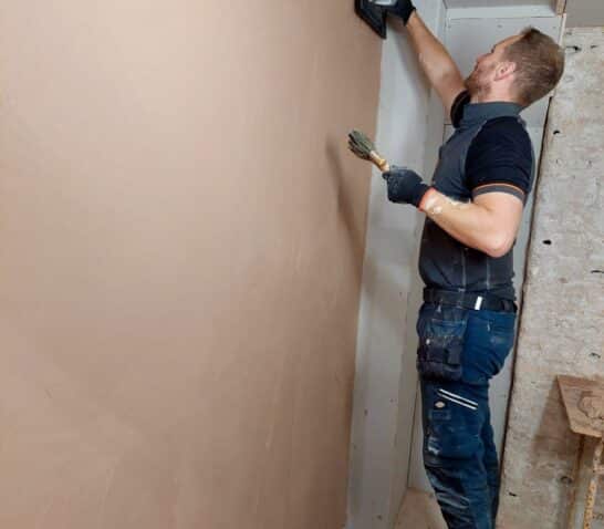 Person skimming a wall on a plastering course