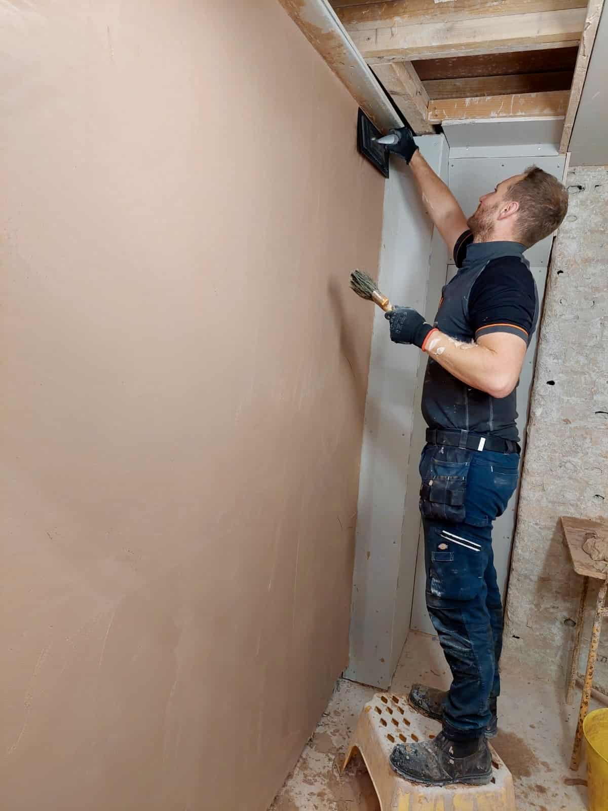 Person skimming a wall on a plastering course