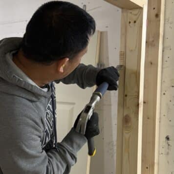 Person using chisel on door casing on carpentry course