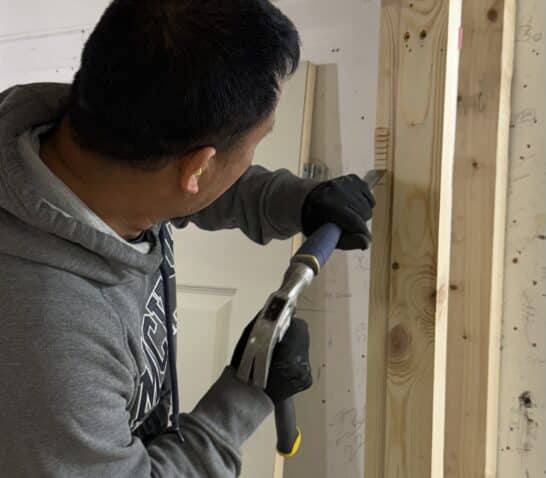 Person using chisel on door casing on carpentry course