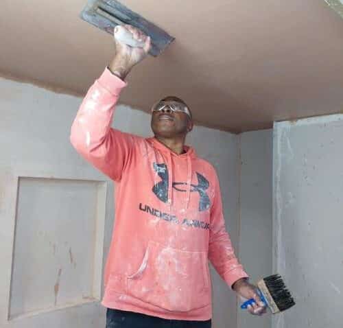 a man plastering a ceiling