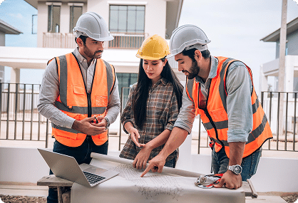 two men and a lady reviewing plans for a construction building project