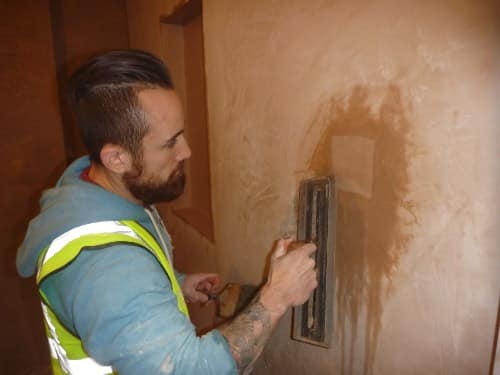 person completing plastering patch and repair work