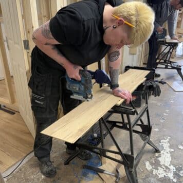 lady cutting laminate flooring