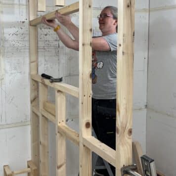 lady making a window opening in a stud wall