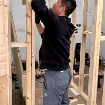 person cutting hinge recess for door