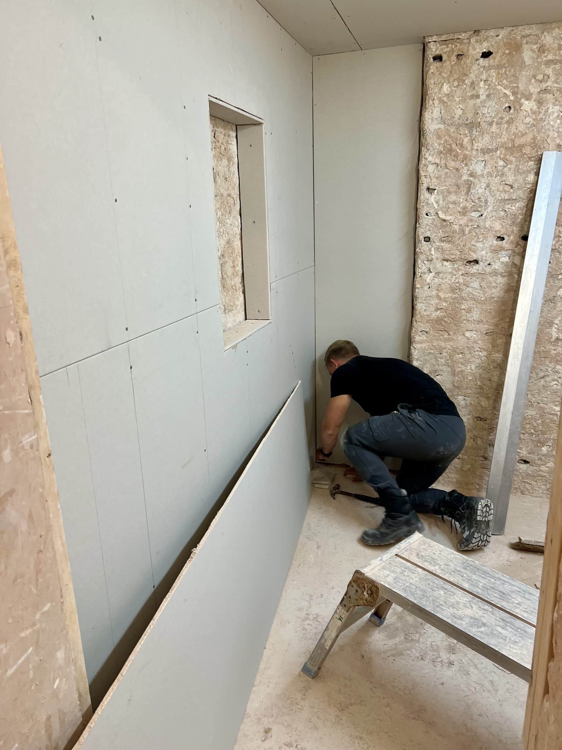 person cutting plasterboard