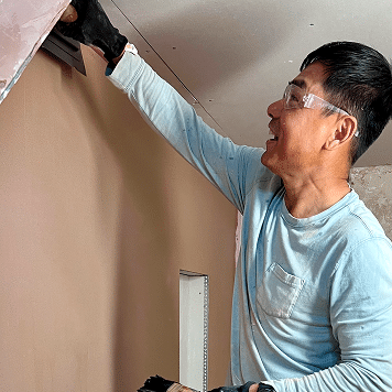 person getting a good finish on the wall in their training bay