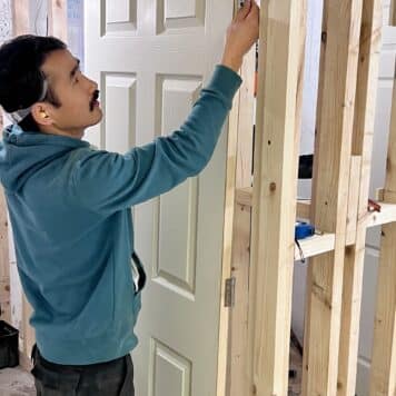 person hanging a door