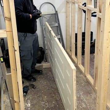 person preparing door for hanging