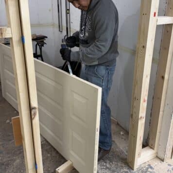 person using a chisel to cut out for hinge