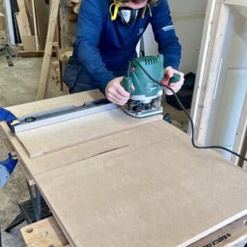 person using router to build a cabinet