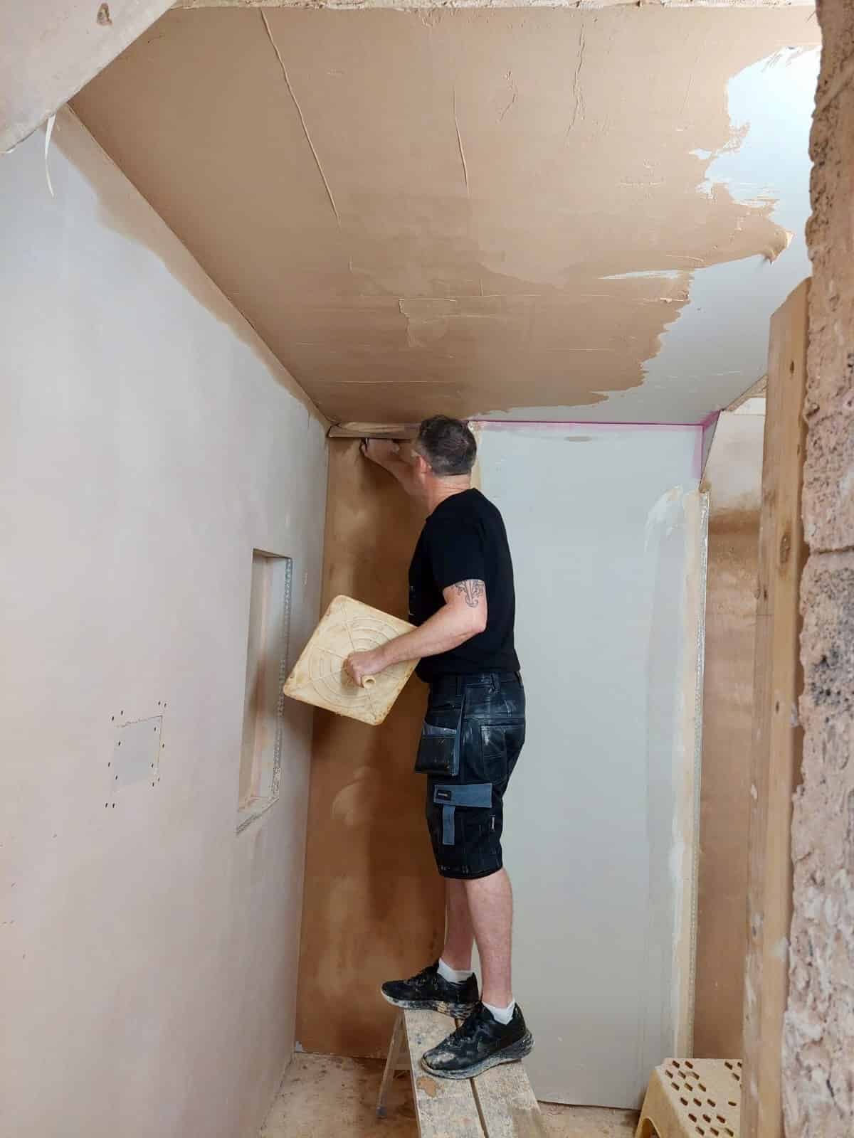 person who is skimming a ceiling