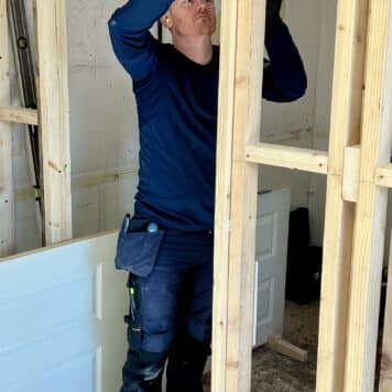 a man marking out his door casing during his course