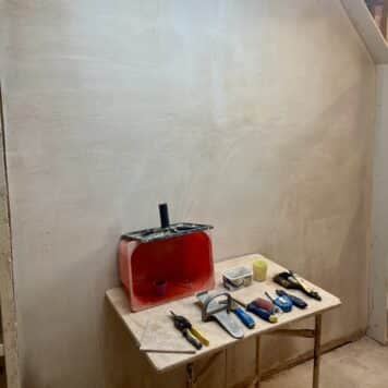 a plastered wall completed on day two of a plastering course