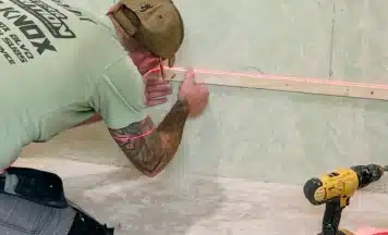Student from Kent using a laser level on his tiling course
