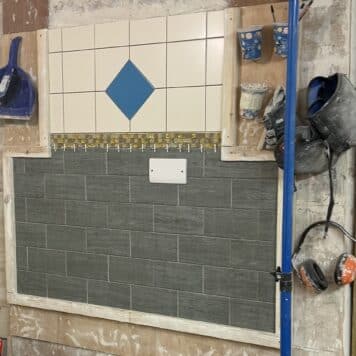 brick wall effect tiling on course in Stoke-on-Trent