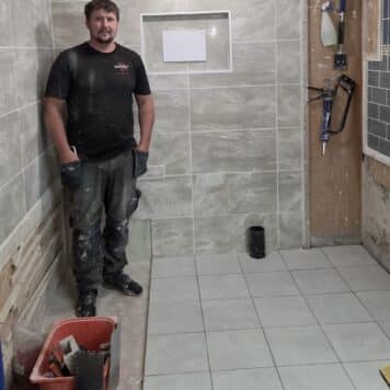 Person showing completed project on his tiling course
