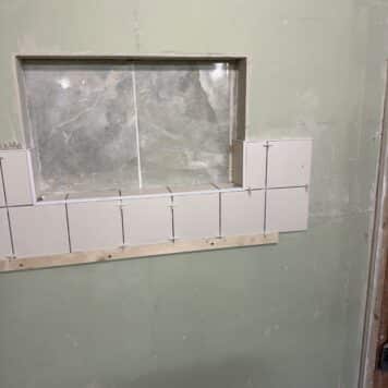 tiling in and around a window on tiling course